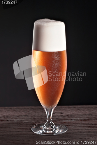 Image of Beer into glass on table
