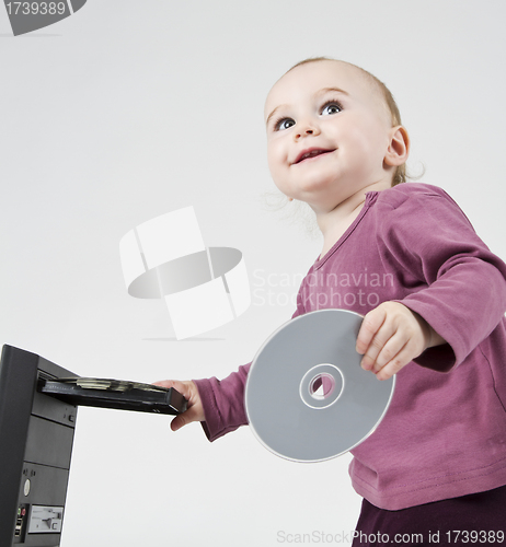 Image of young child playing with CD