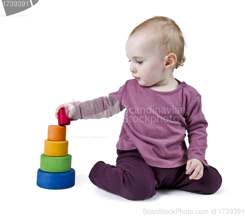 Image of young child playing with colorful toy blocks