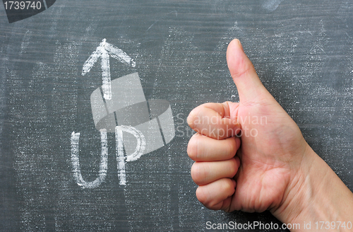 Image of Up - word written on a blackboard with an arrow and thumb up gesture