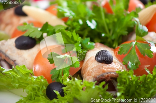 Image of stuffed eggplants and salad with tomatoes and olives