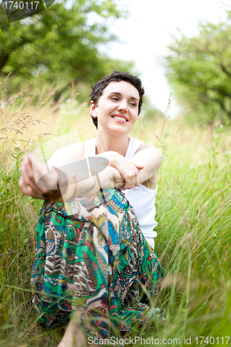 Image of girl resting on fresh spring grass 