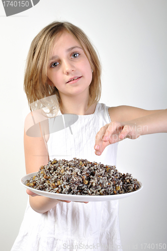 Image of childl with traditional European Christmas food kutia