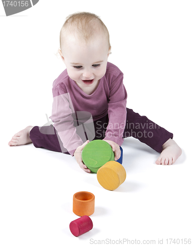 Image of young child playing with colorful toy blocks