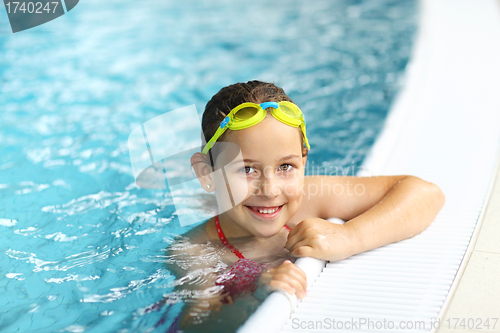 Image of Girl with goggles in swimming pool