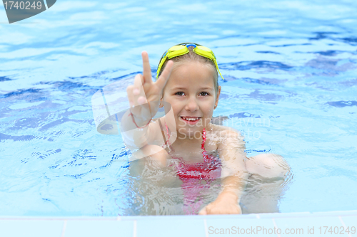 Image of Girl with goggles in swimming pool