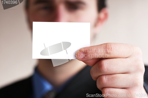 Image of Businessman holding card