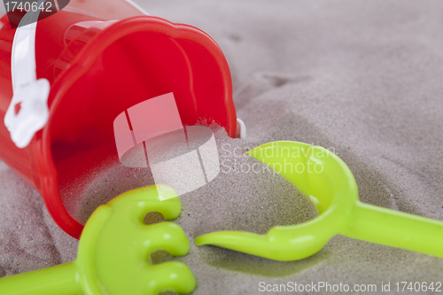 Image of colorfull miniature toys in sand on beach