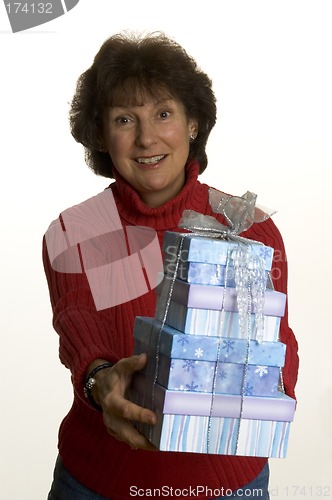 Image of happy woman with gifts stack