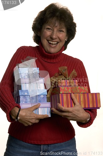 Image of happy woman with gifts stack