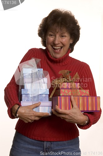 Image of happy woman with gifts stack