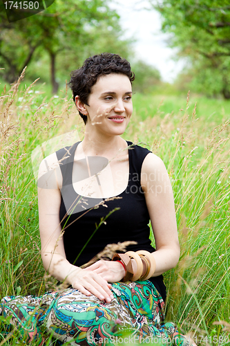 Image of girl resting on fresh spring grass 