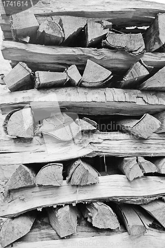 Image of Background of dry chopped firewood logs stacked up on top of eac