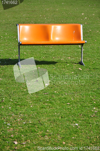 Image of Orange bench on lawn