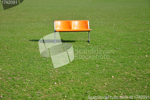 Image of Orange bench on lawn