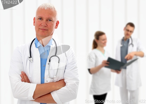 Image of Senior doctor with his arms crossed