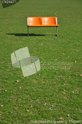 Image of Orange bench on lawn