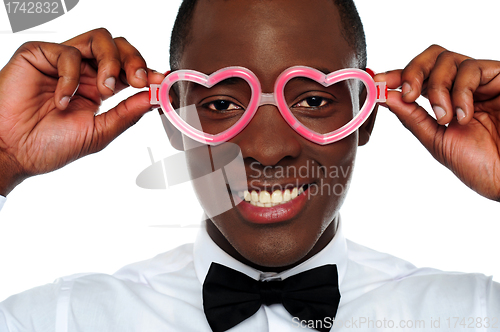 Image of Smiling man wearing heart shaped eye-wear