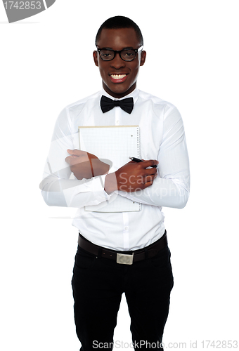 Image of African guy holding spiral notebook