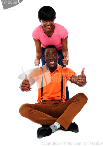 Image of Couple showing double thumbs-up to camera