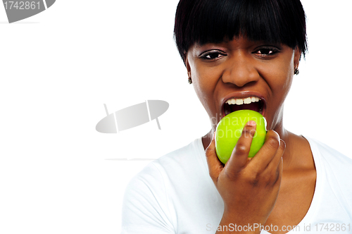 Image of Close up shot pretty lady eating green apple