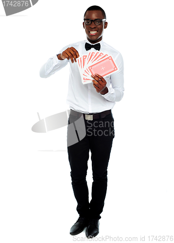 Image of Portrait of a young man holding cards