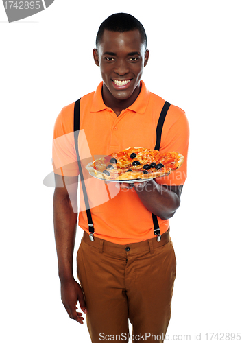 Image of Smiling young african boy offering pizza