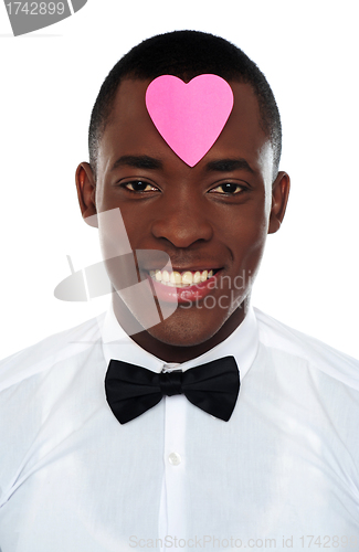 Image of African man with pink paper heart on his forehead