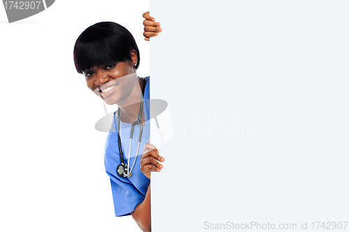 Image of Female doctor holding long blank banner ad