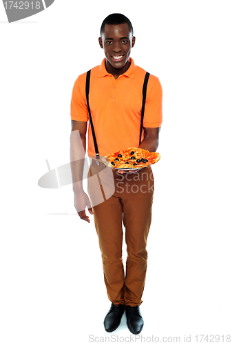 Image of Full length portrait of delivery boy with pizza