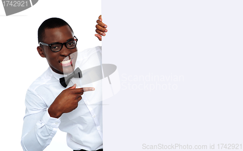 Image of Black man pointing at blank placard