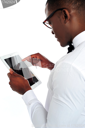 Image of Rear-view of african holding a touch-pad device