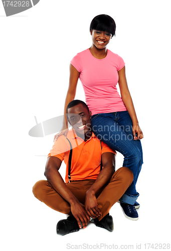 Image of Woman in casuals sitting on mans shoulder