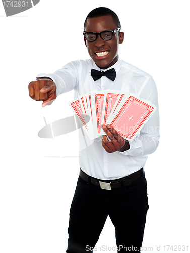 Image of Gambler with playing cards pointing at you