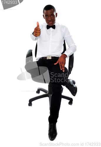 Image of Confident man with thumbs-up gesture