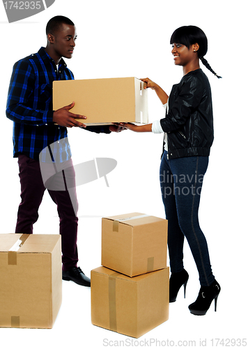 Image of Couple moving empty cartons