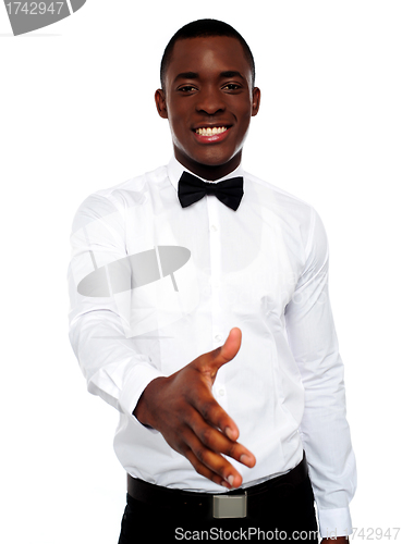 Image of Attractive young man offering handshake