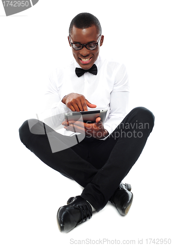 Image of African boy watching video on tablet pc