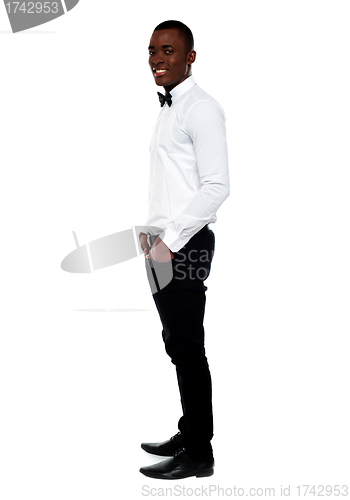 Image of Full length view of smart young man. Side pose
