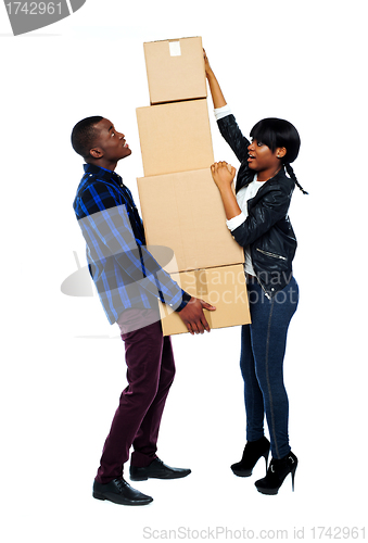 Image of A young couple holds boxes in studio