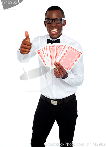 Image of Handsome man holding a trump. Thumbs-up