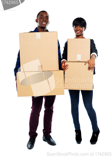 Image of Attractive african couple holding cardboard boxes