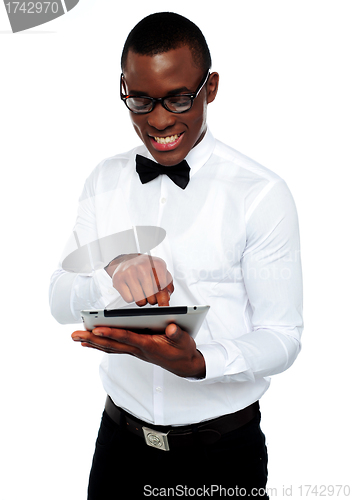 Image of Smiling african boy using tablet-pc