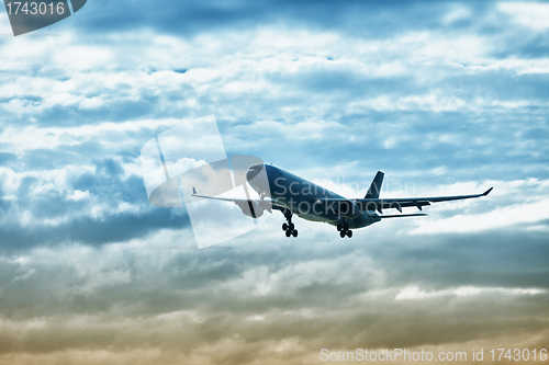 Image of Airliner landing on evening sky