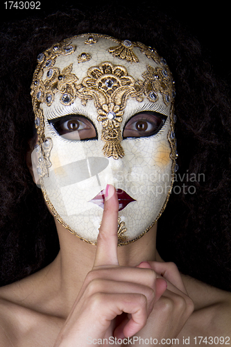 Image of Woman wearing a beautiful venetian mask