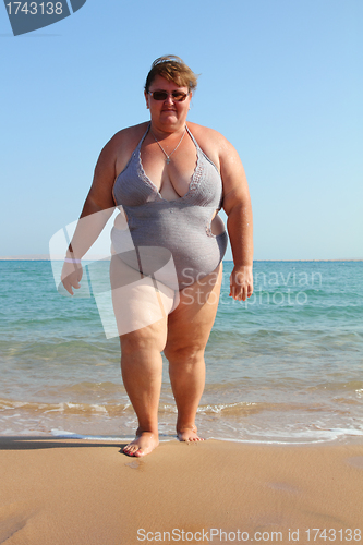 Image of overweight woman on beach