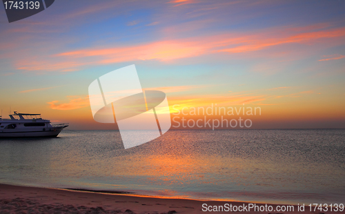 Image of ship at anchor on sea before sunrise