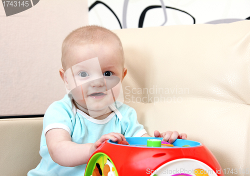 Image of happy baby with toy