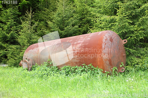 Image of rusty cauldron left in the woods