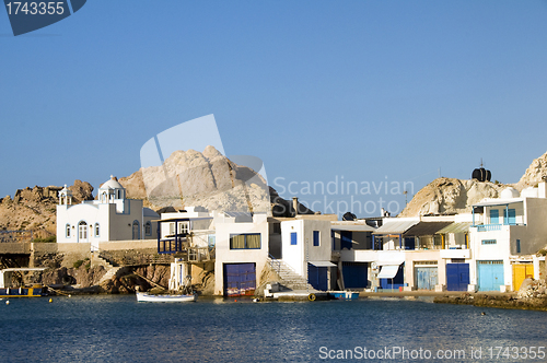 Image of  houses built into rock cliffs on Mediterranean Sea Firopotamos 